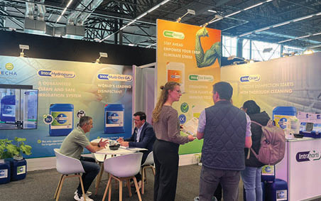People at a trade fair booth at GreenTech
